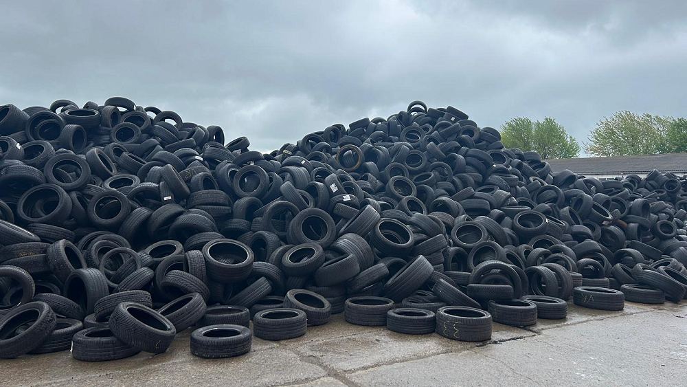 Pile of sorted waste tyres in a working yard