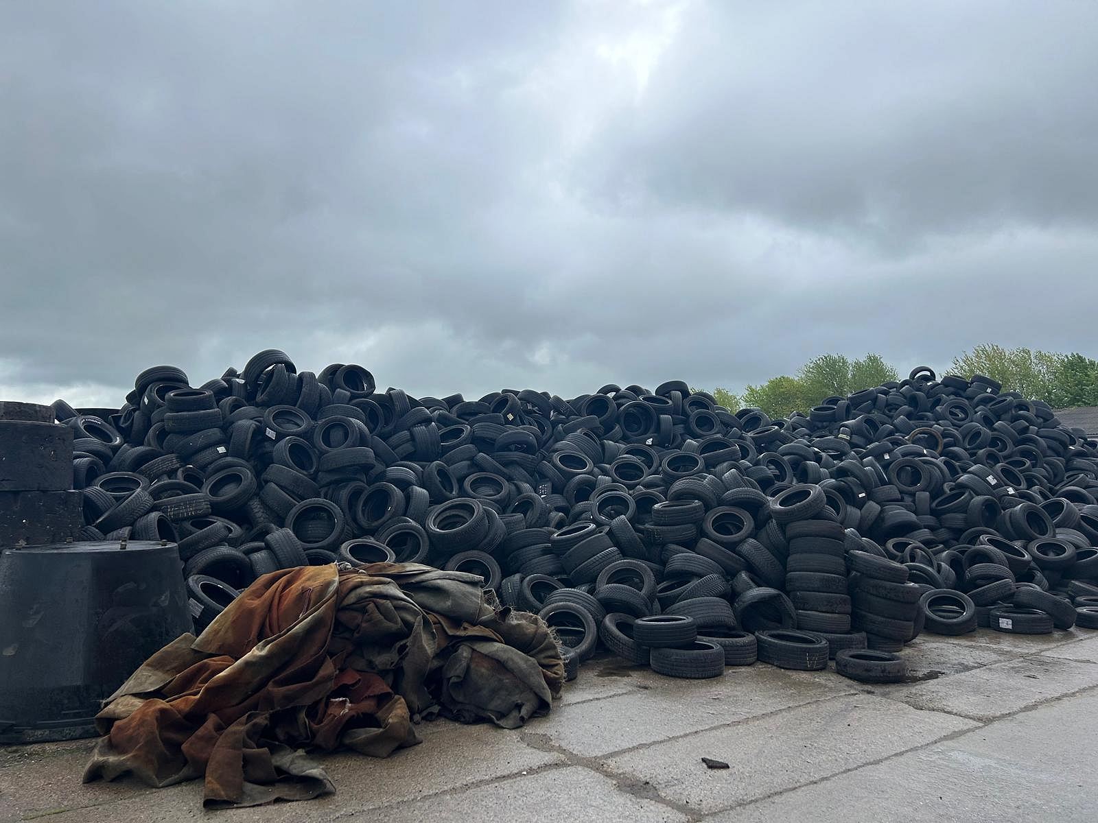 Sorted end-of-life tyres in a covered store before processing